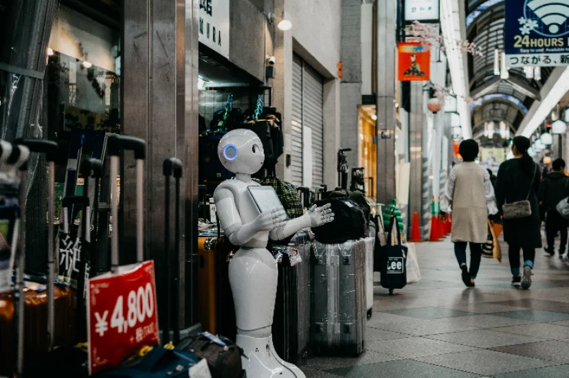 Robot standing by luggage_Photo by Lukas on Unsplash.png