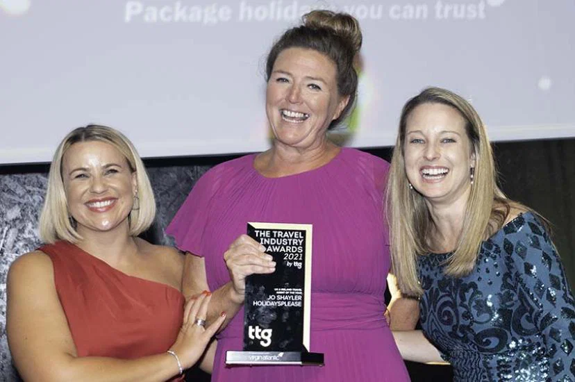 Jo Shayler (middle) collects her award at the Travel Industry Awards by TTG