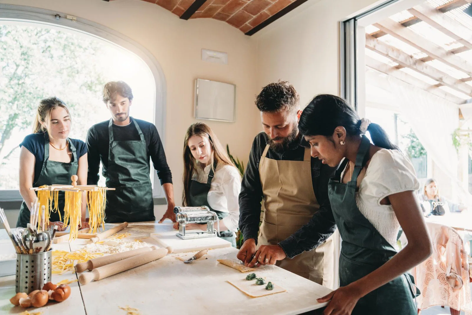 Young travellers pasta making class in Italy