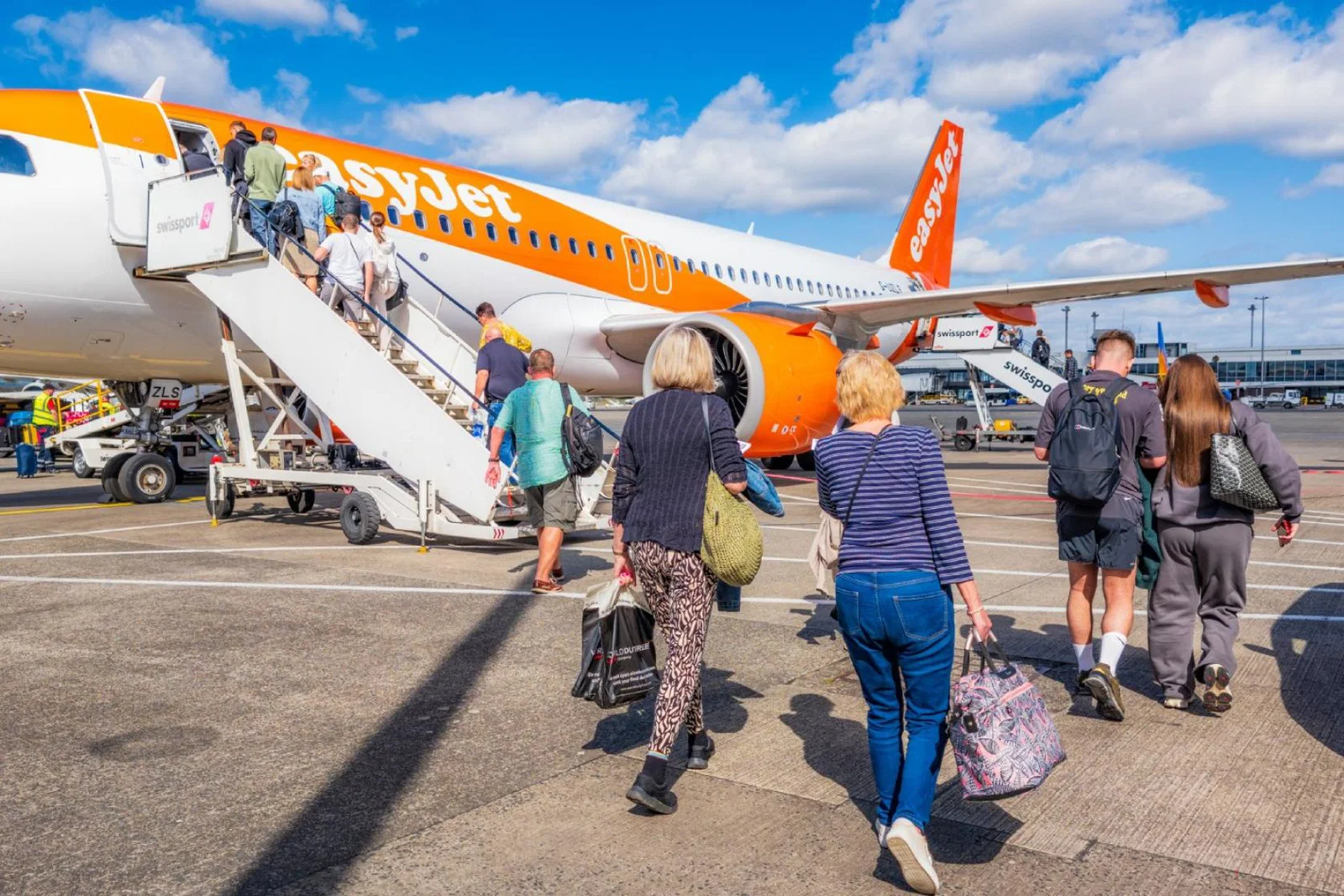 Passengers board an easyJet aircraft