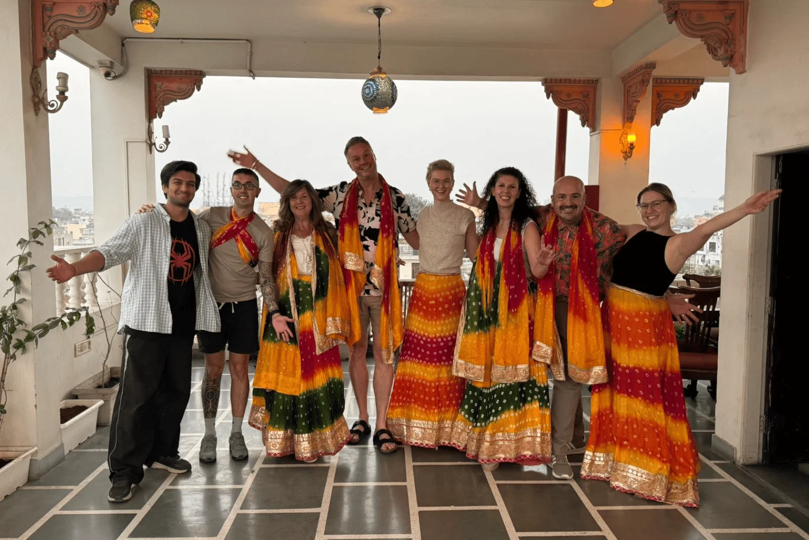 The TTG Travel Ambassadors smile at the camera wearing traditional Bollywood skirts and scarfs 