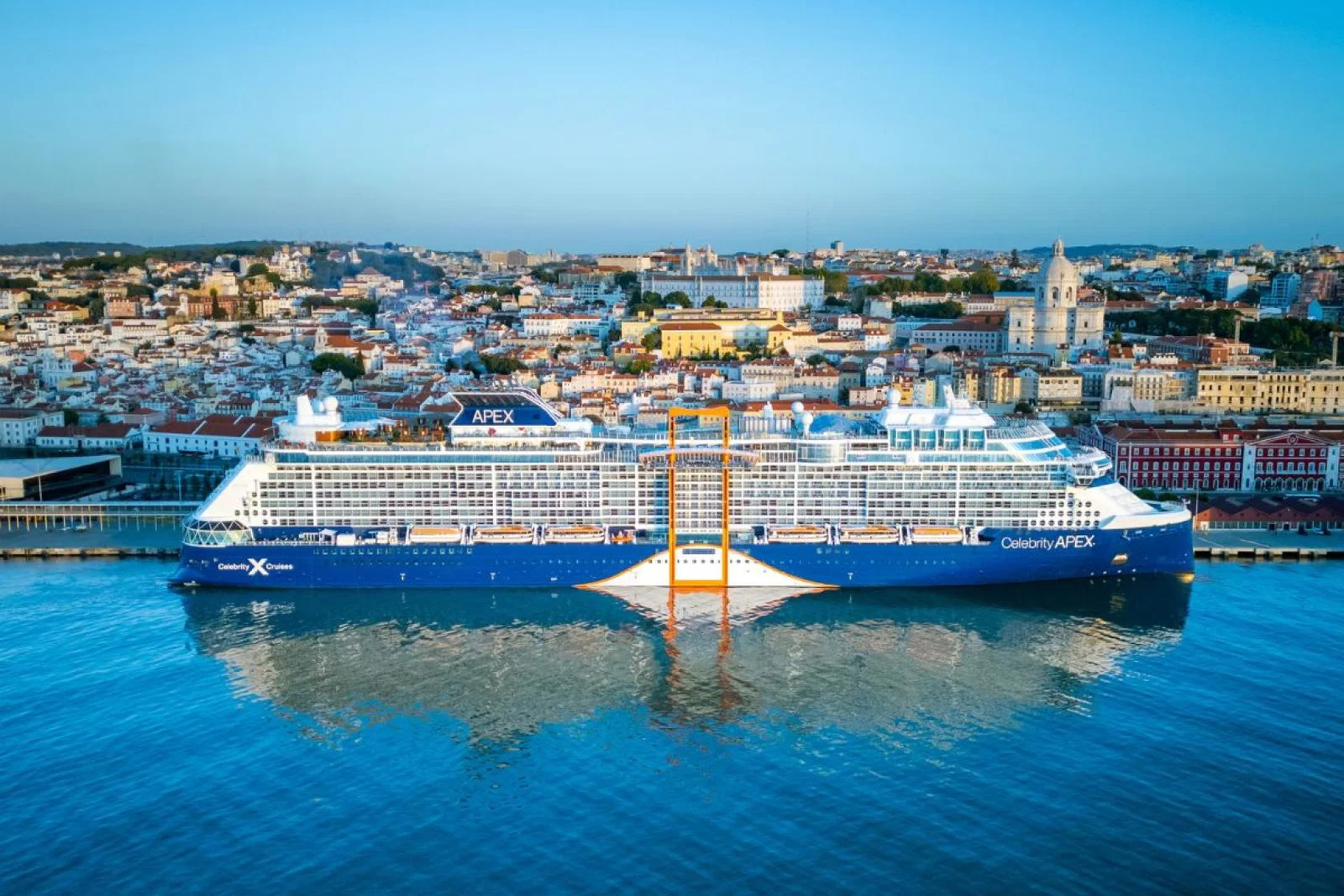 Celebrity Apex ship docked up with Lisbon city landscape in the backgroun