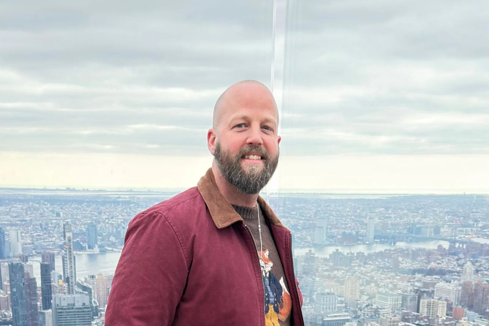 Man smiling with New York City background