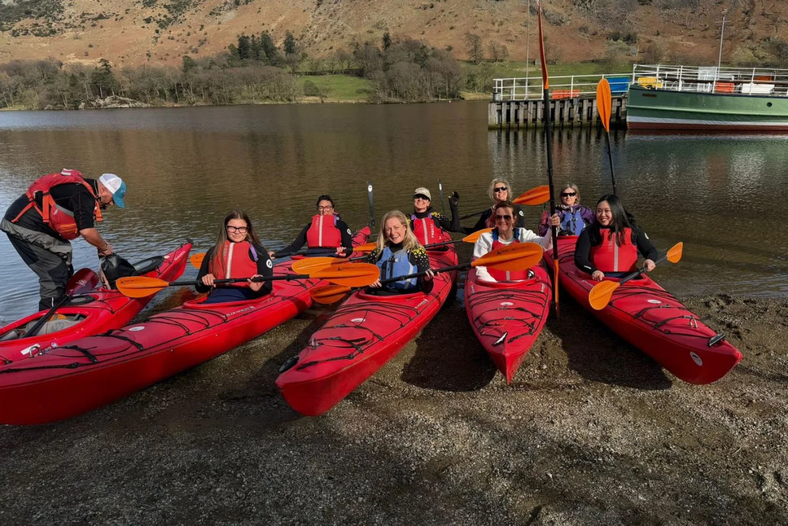 Five women in red kayaks 