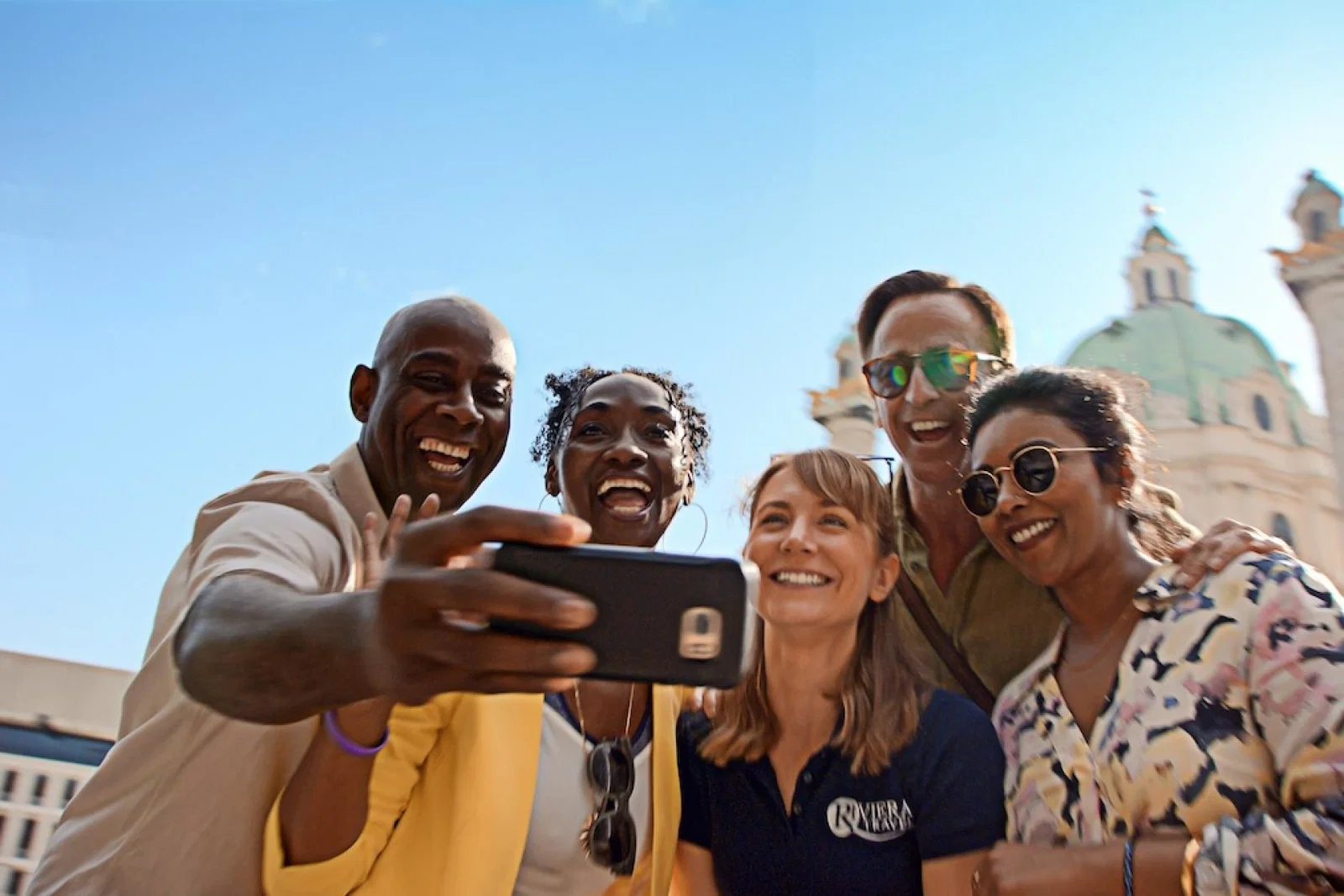 Group of people pose in front of landmark for a selfie