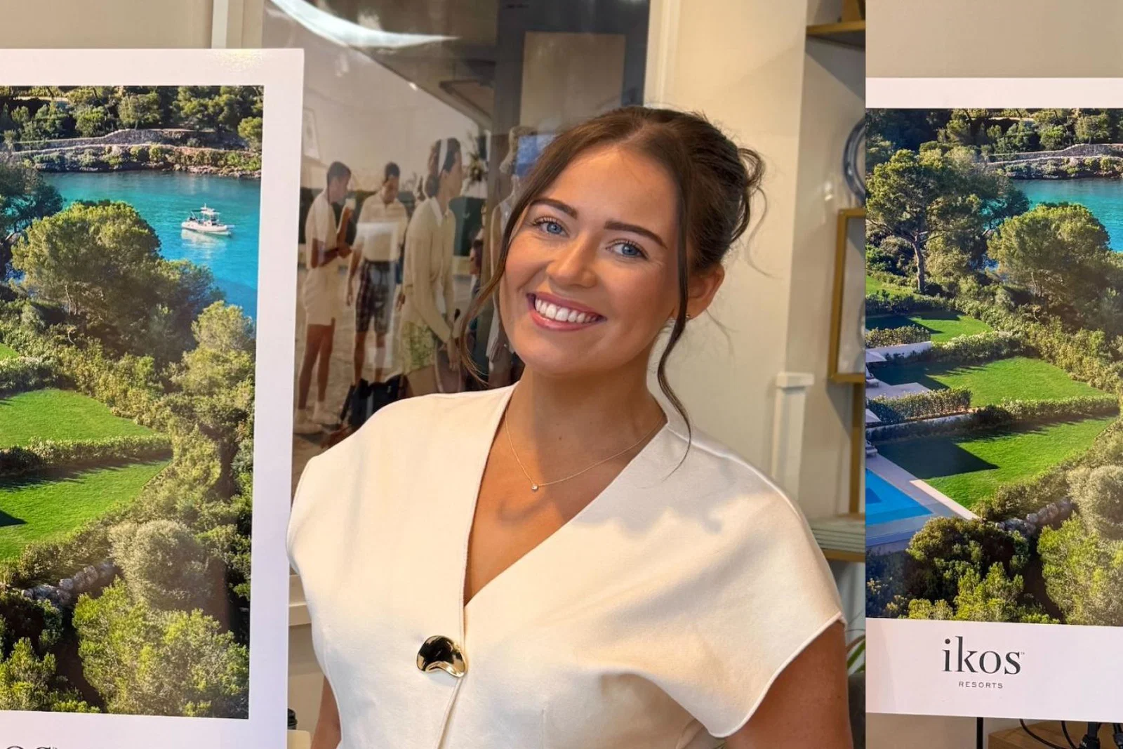 Brown haired woman smiling in white top 