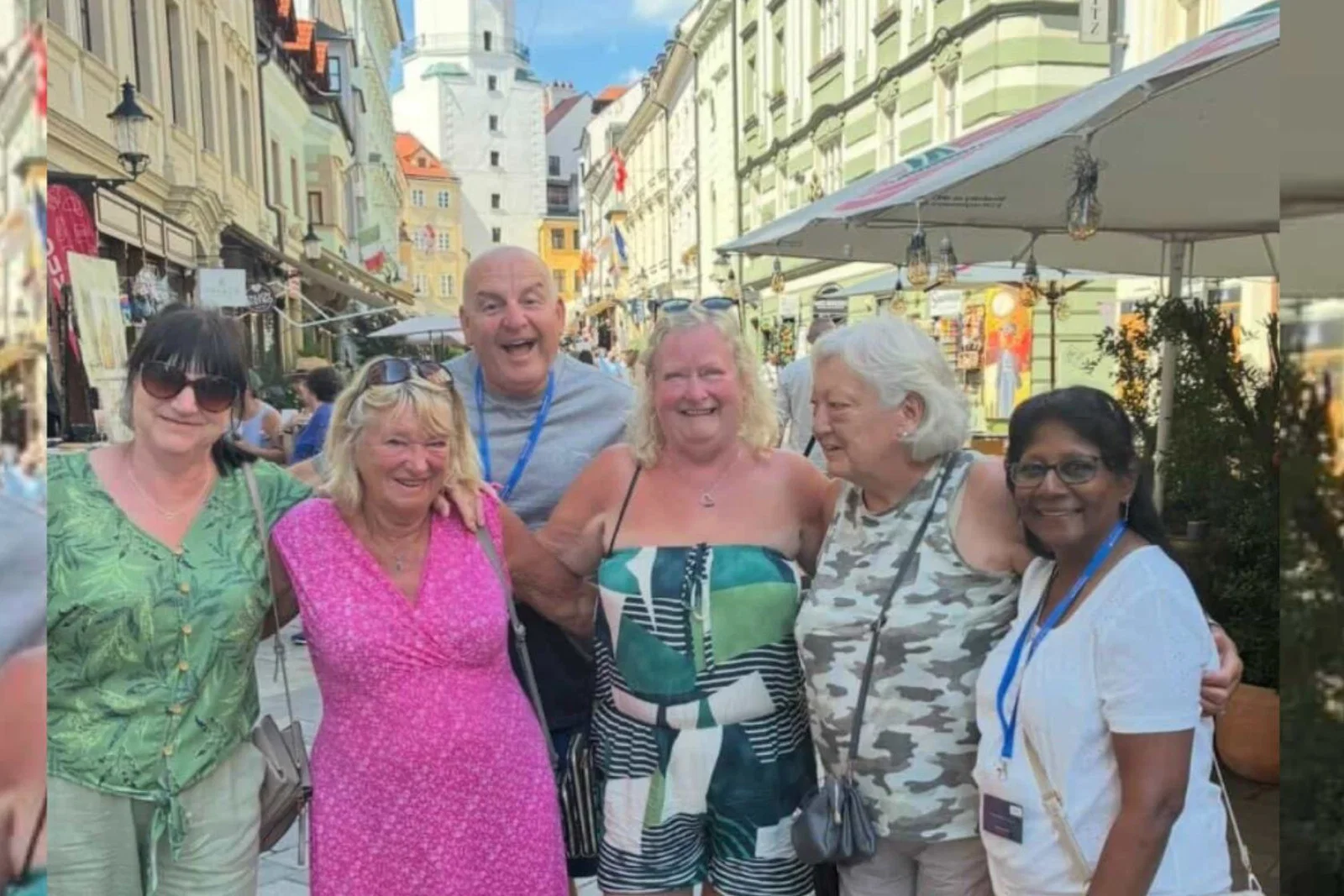 Group of people smiling on holiday on European street 