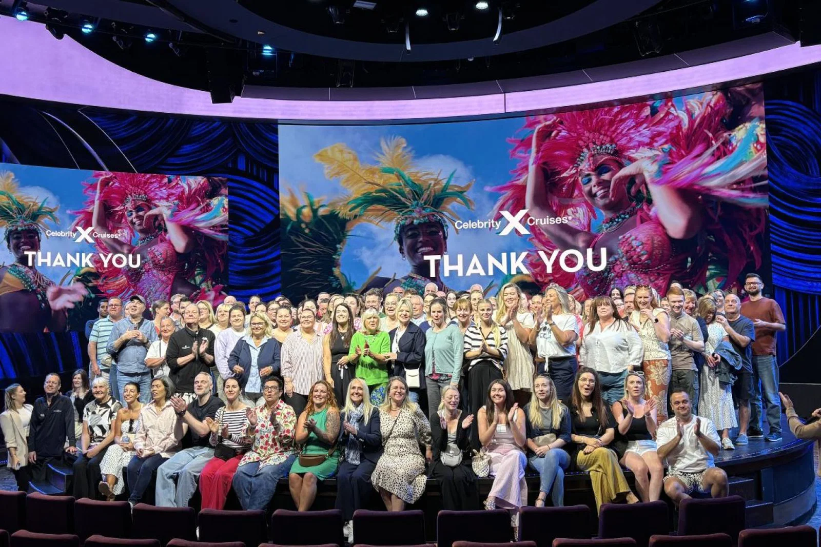 Hundreds of agents gather on stage for a group photo