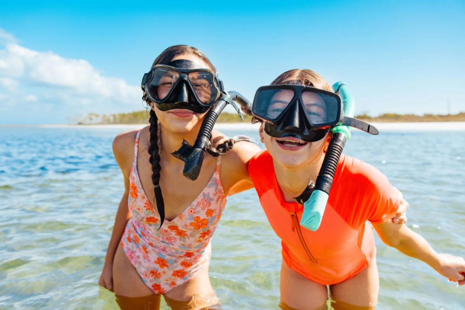 Young boy and girl in snorkels smiling at camera 