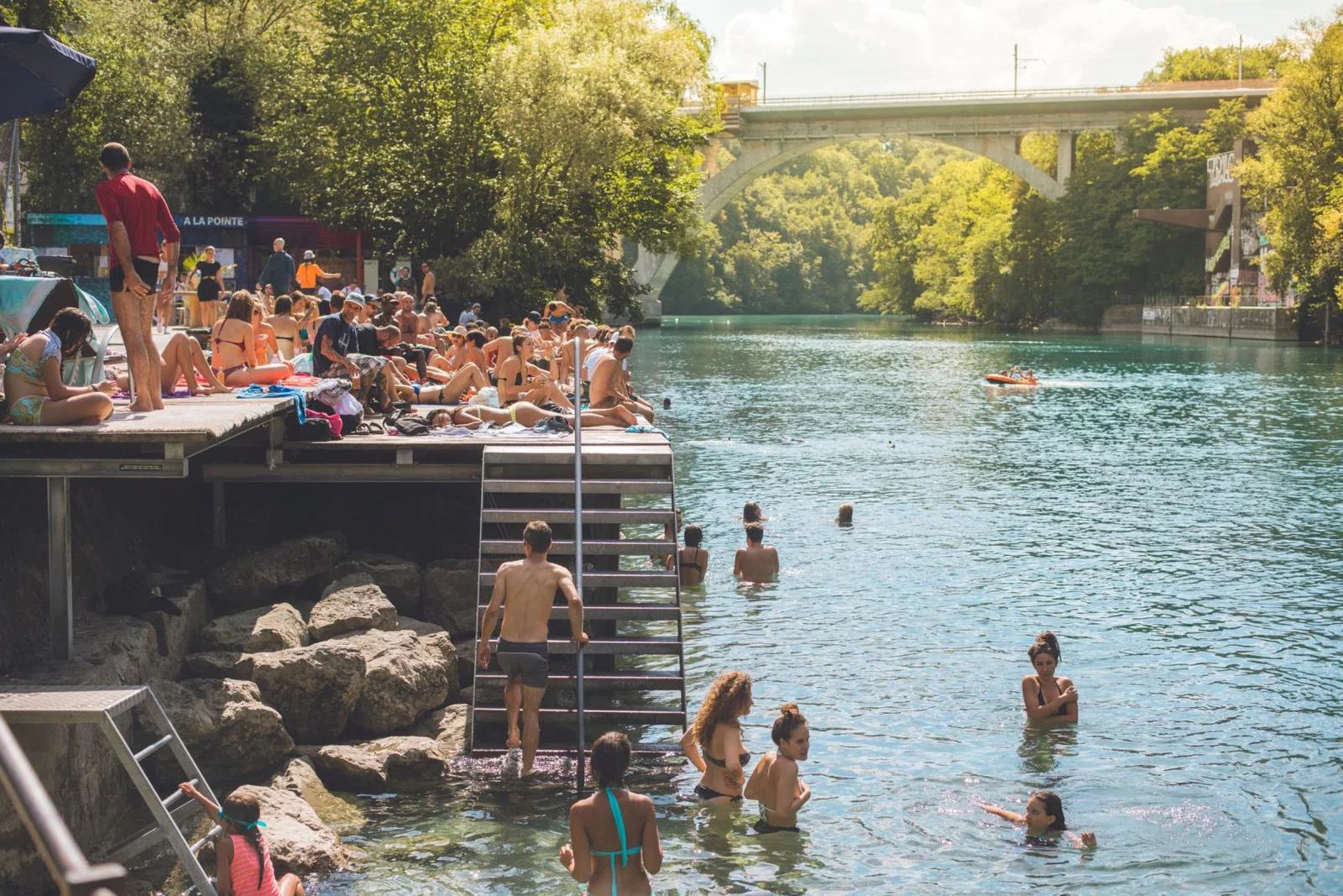 People enjoying a refreshing swim in Rhone River, Geneva