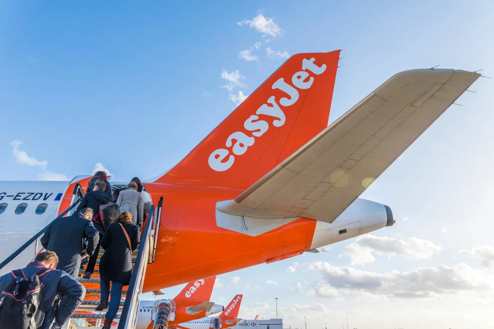 Passengers board an easyJet aircraft via the rear entrance