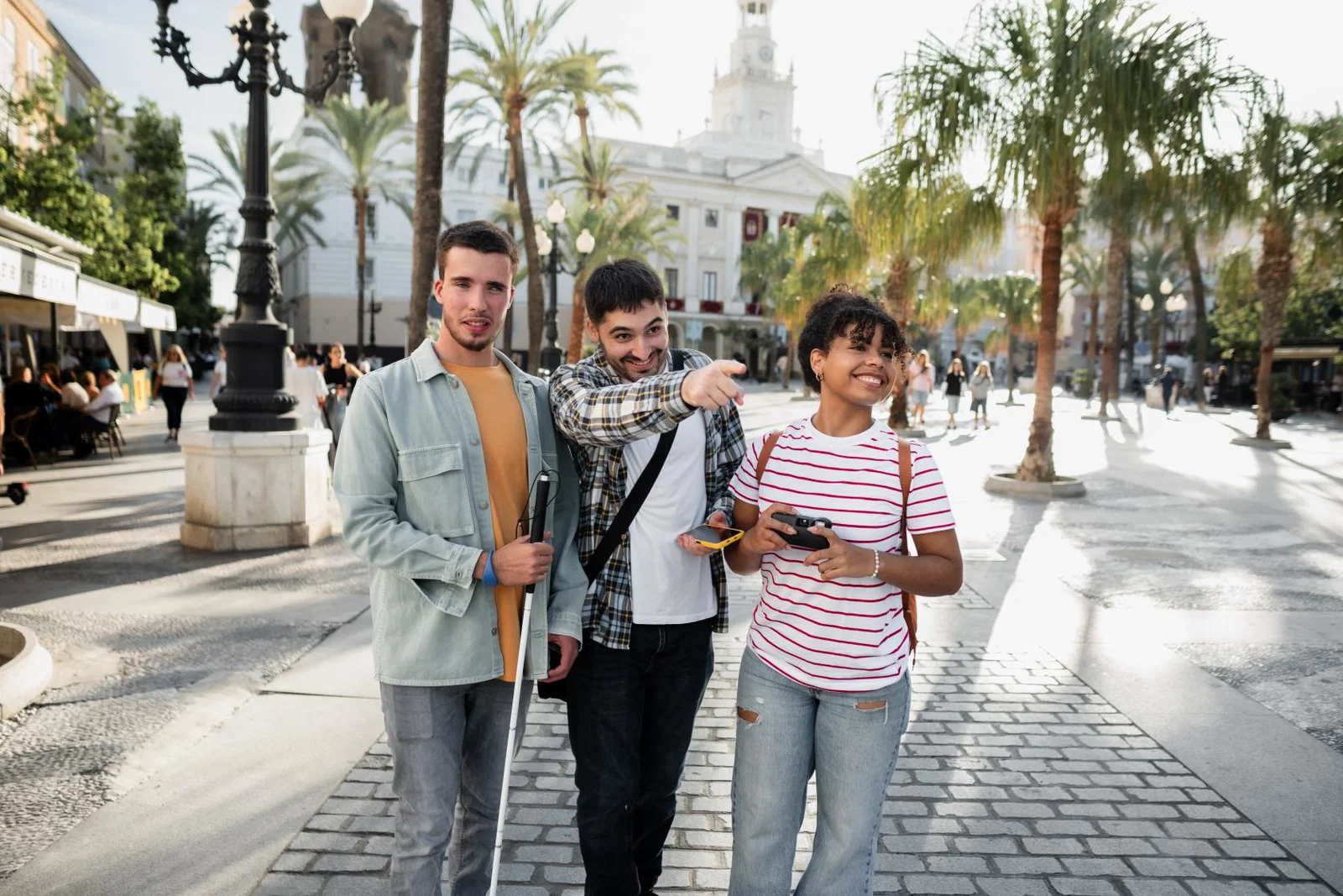 Friends travelling, one with sight stick