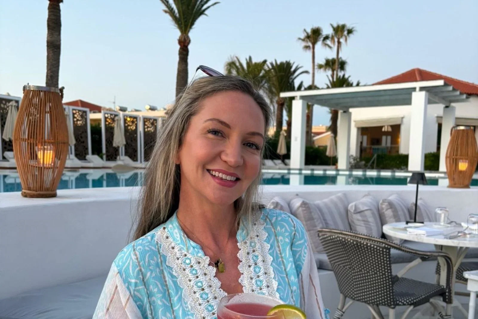 Smiling woman with long brown hair on holiday