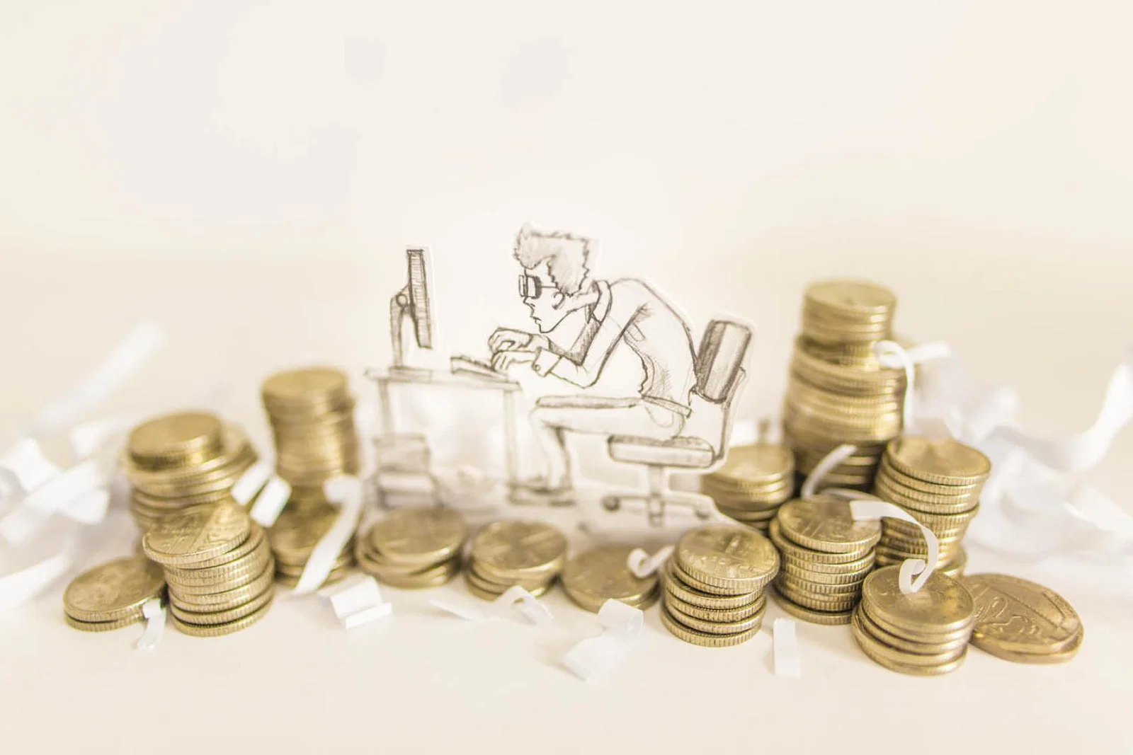 Tax / money - man working among coins (stock)