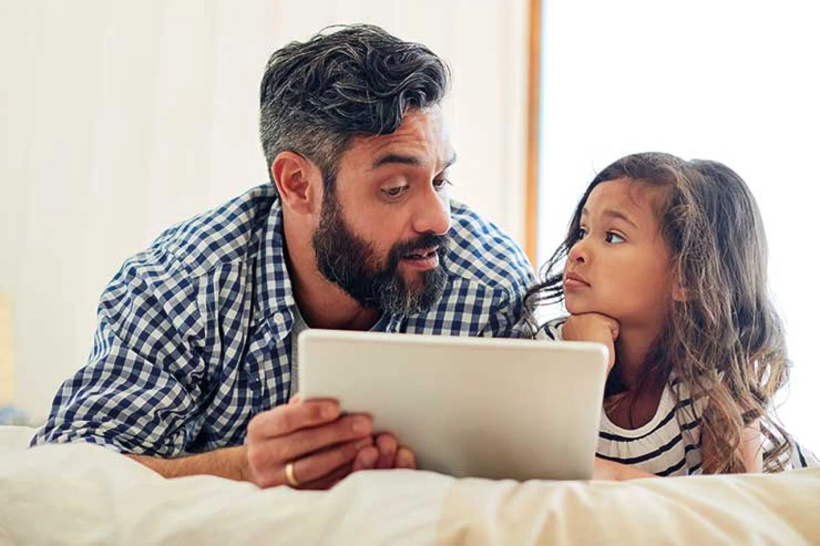 Father and child with tablet device