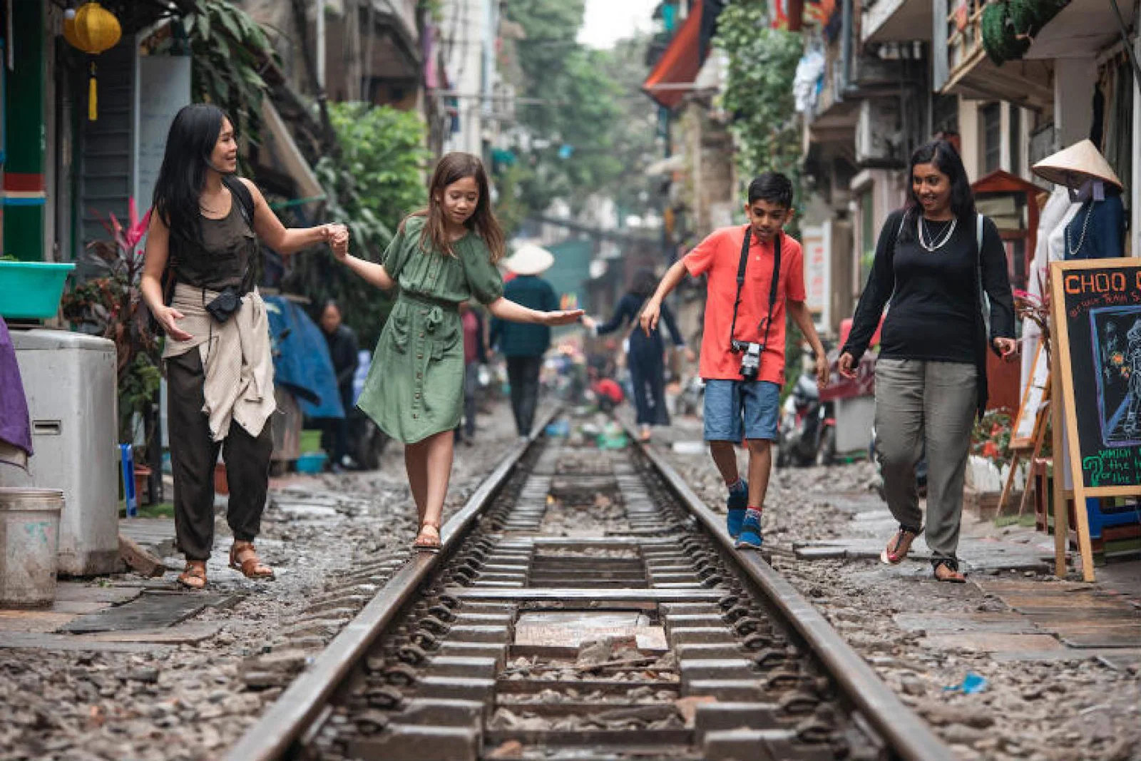 G Adventures National Geographic Vietnam Hanoi Train Street Mothers Children Walking.jpg