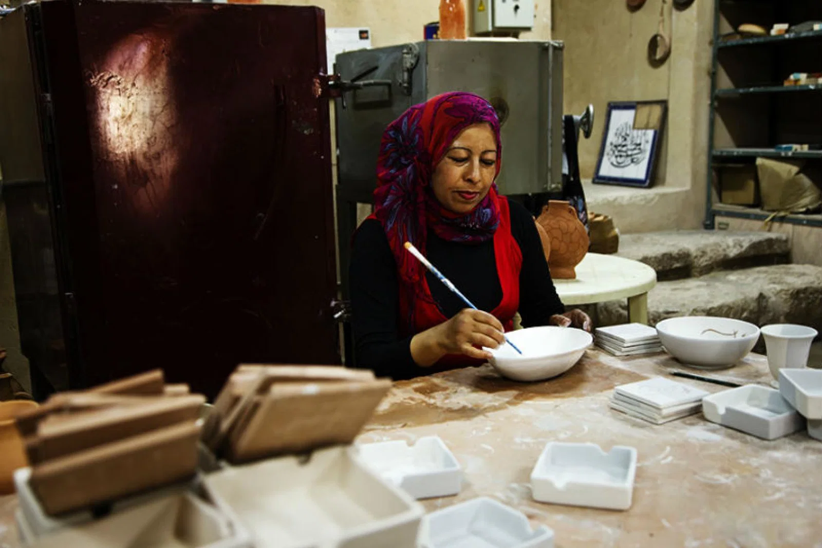 Iraq al Amir woman painting pottery