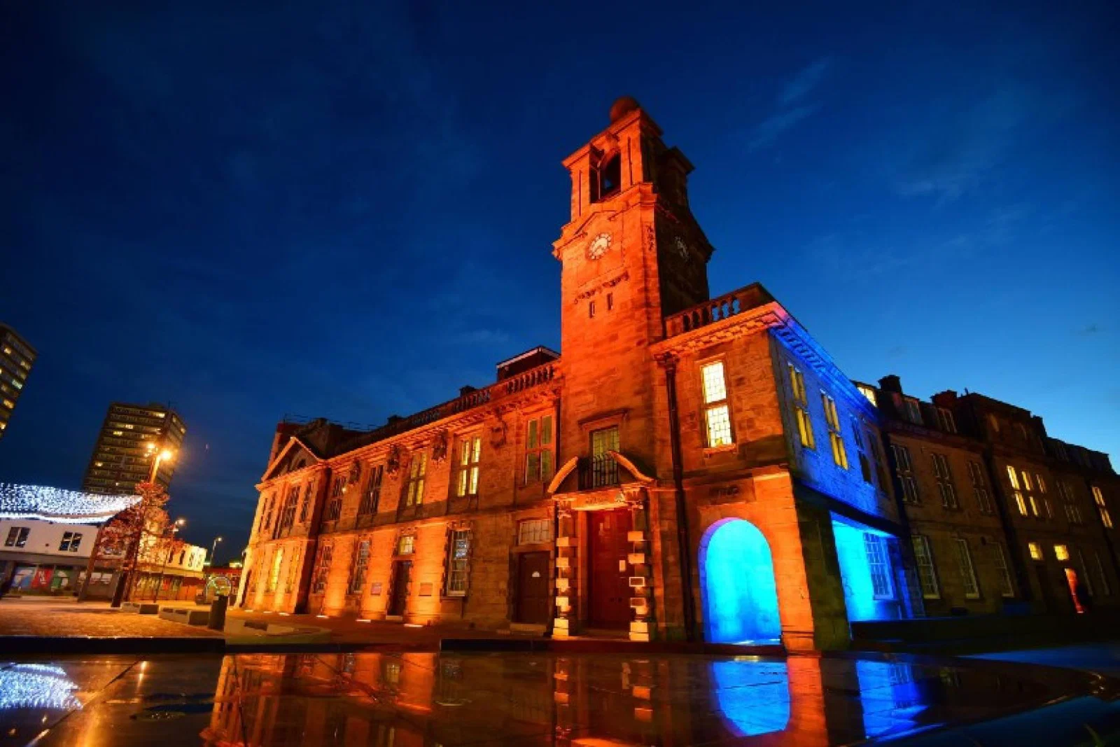 Several city landmarks have been lit up in blue and orange in tribute to John Hays