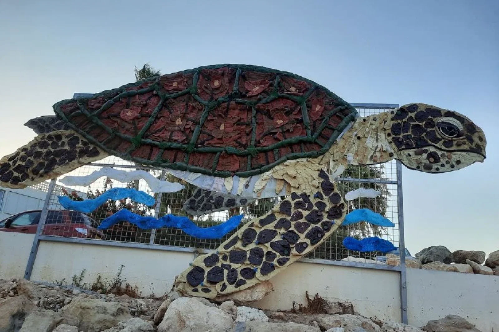 Made entirely from plastic waste, the turtle artwork, named "Calypso", is in a "prominent" position at Ayia Triada beach to raise awareness of the issue of plastic pollution