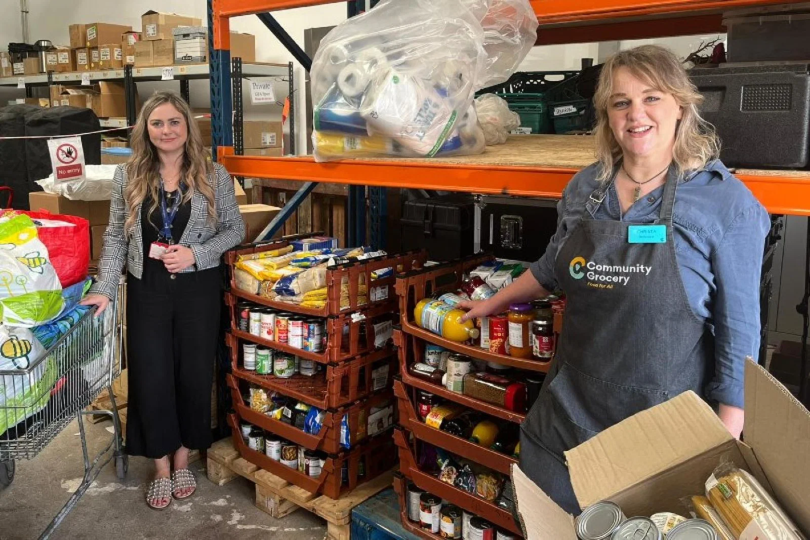 Chair of the Airport Community Network Emma Stone (left) handed over the donations to the Message Community Grocery