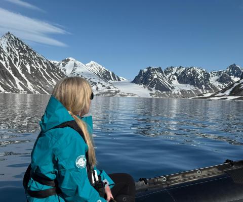 Rebecca Barnes rides on a Zodiac in Svalbard