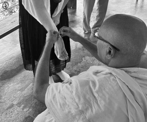 Caroline being blessed by monk