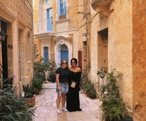 Cerys and colleague post in pretty street in Malta