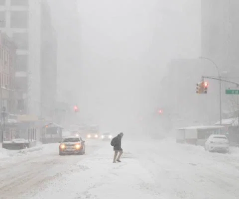 Lone walker crossing a New York street during a blizzard