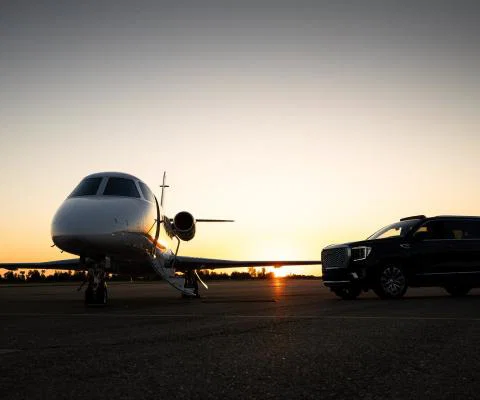A private jet sitting on a runway at dusk