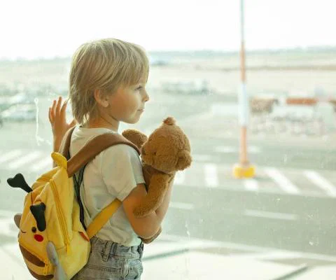 Child looking out of airport window