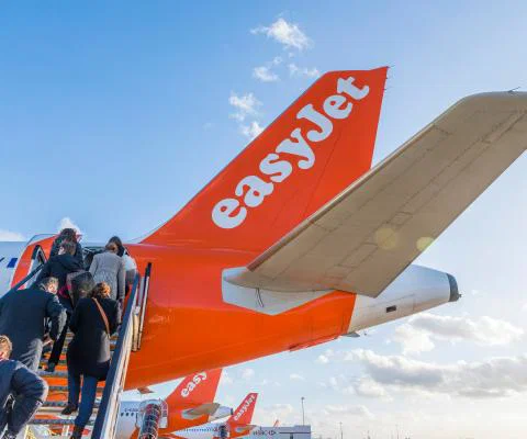 Passengers board an easyJet aircraft via the rear entrance