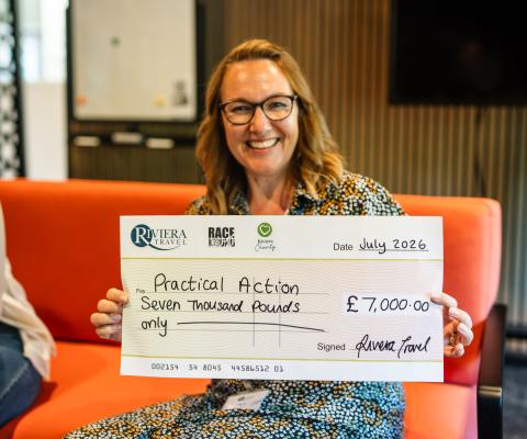 Office Manager and Head of Charity at Riviera Travel, Jane Walker, presenting Practical Action with a cheque for £7,000 