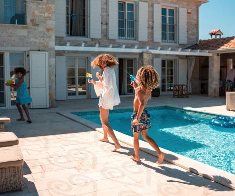 A family play together by a pool