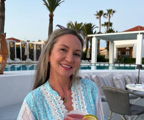 Smiling woman with long brown hair on holiday
