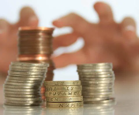 Tax - reaching for coins (stock)