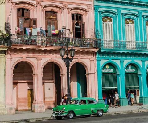 1950s vintage car parked in front of buildings in Old Havana Cuba