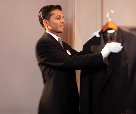 Butler combing a jacket