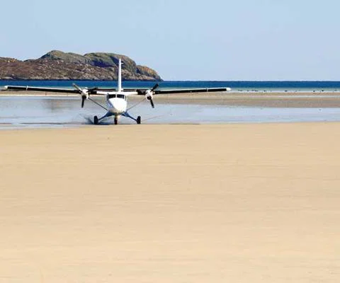 Light aircraft landing on beach iStock-174798675