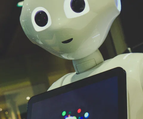 AI Robot holding tablet_Photo by Owen Beard on Unsplash.png