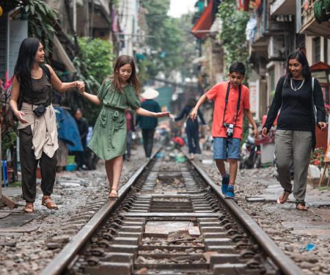G Adventures National Geographic Vietnam Hanoi Train Street Mothers Children Walking.jpg