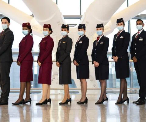 Cabin crew from British Airways and Qatar Airways celebrate plans to expand the two carriers' joint business
