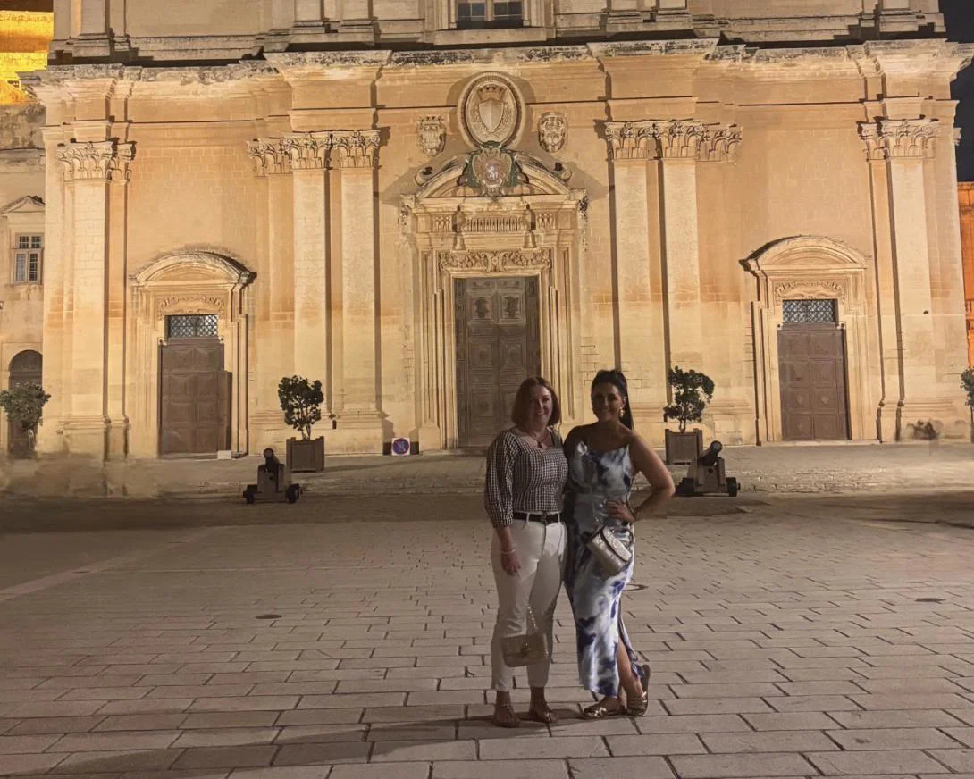 Cerys Stagg O’Connell and colleague pose in front of historic cathedral