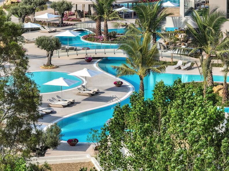 View of lagoon pools and sunloungers at Sani Resort
