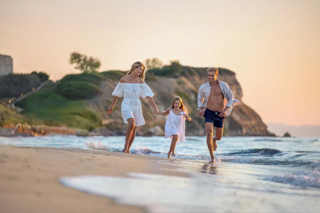 A family playing on Bousoulas beach at Sani Resort