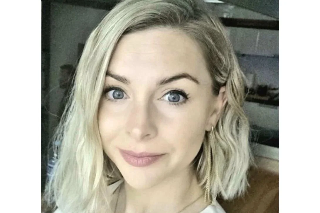 Woman with shoulder-length blonde hair smiling at camera
