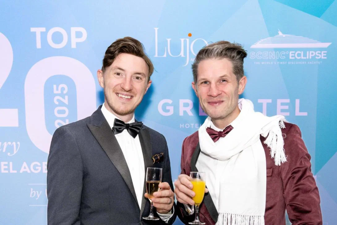 Two men smiling at fancy event
