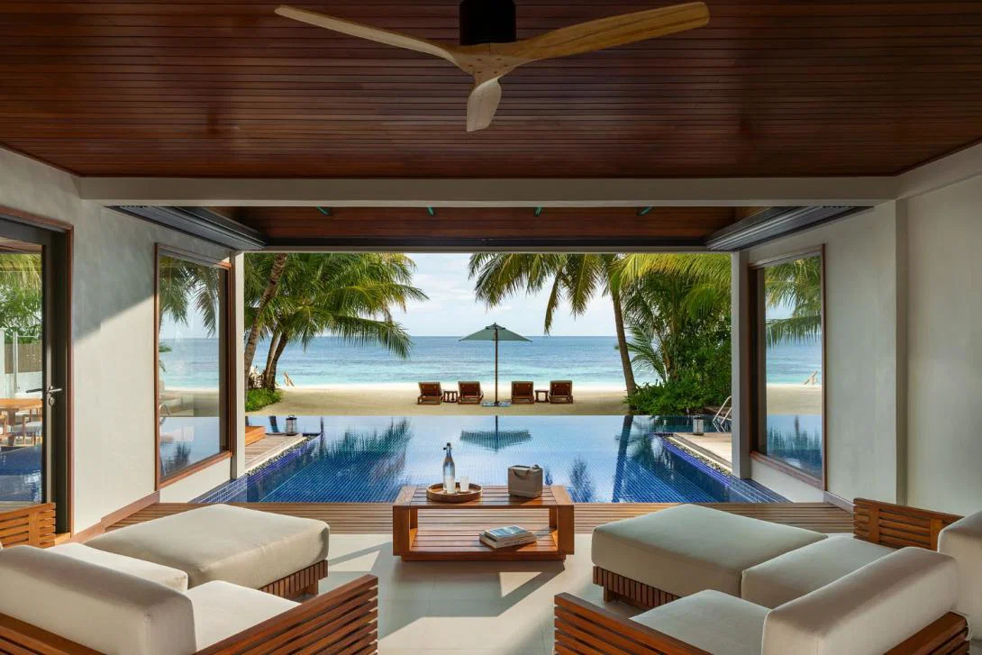 Luxury Maldives villa interior looking out at pool