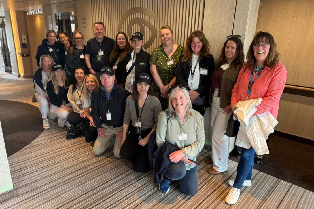 Group of 17 travel agents smiling on fam trip