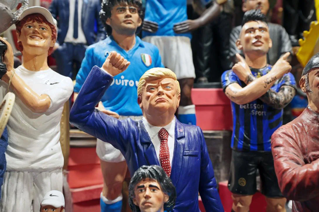A figurine of Donald Trump raising his fist surrounded by sportspeople