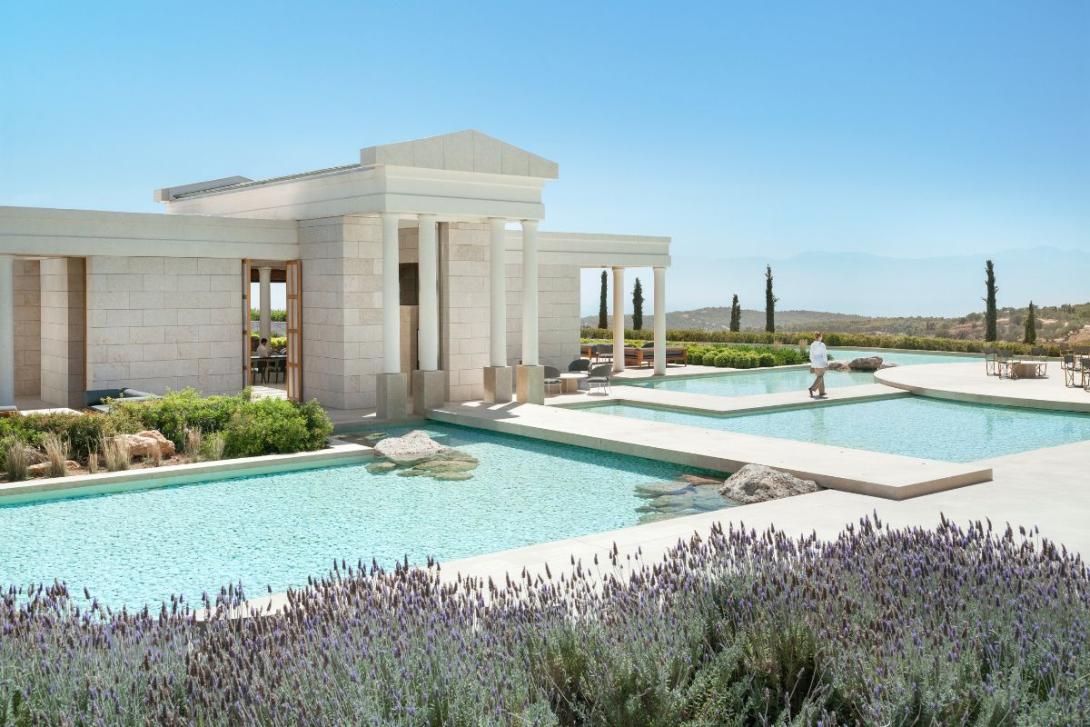 White manor-style villa overlooking pool